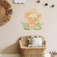 Baby Lion Nursery Wall Sticker in a Boho Nursery with a rattan chair and rattan lion wall decoration.